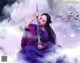 A woman in a purple dress holding a sword.