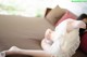 A woman laying on a couch with her feet up.